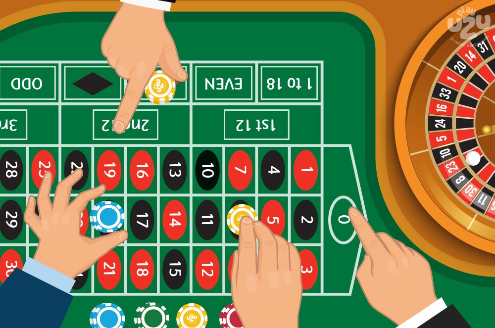 Roulette table, wheel and ball with people's hands placing their bets